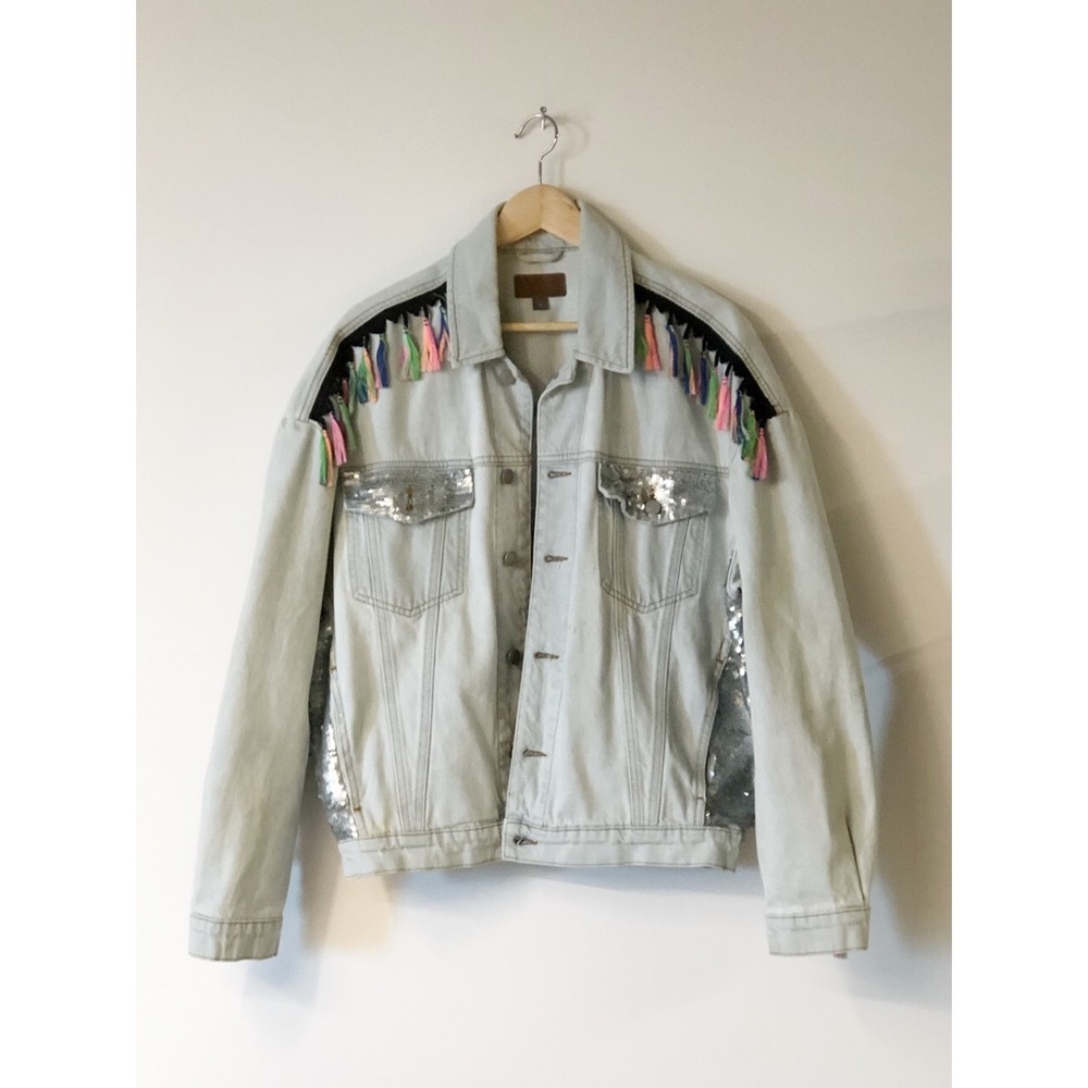 Oversized denim jacket with sequins and tassels.
